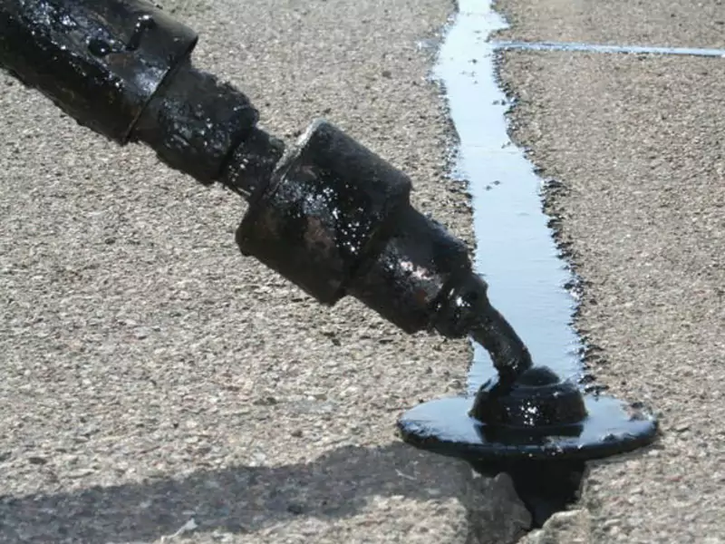 Photo of cracked asphalt being filled