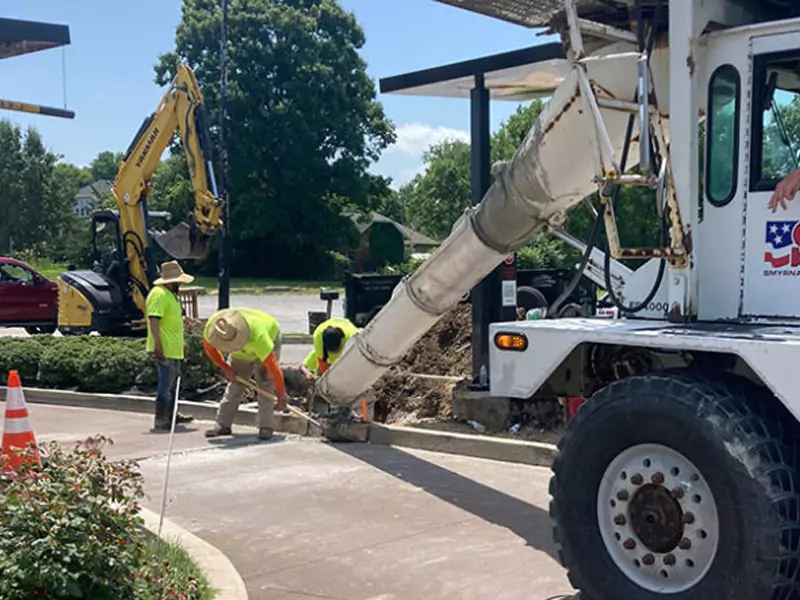Commercial concrete curb repair beside asphalt pavement for a Tampa pavement service page