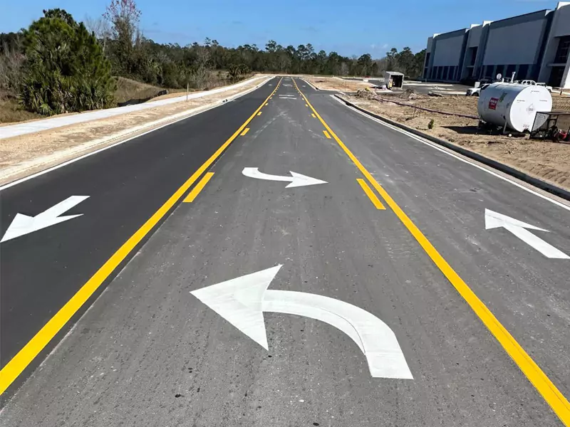 Fresh traffic-control markings at a Florida roadway intersection